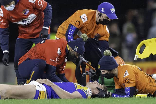 Alex Mellor receives medical attention on the pitch against Catalans Dragons last week. The Leeds Rhinos' player was later given the all-clear. Picture: Allan McKenzie/SWpix.com.