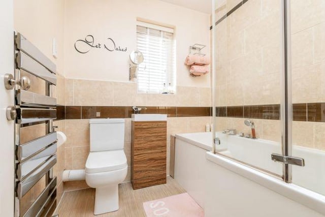 The modern family bathroom is fitted with a three piece suite with shower-end bath.