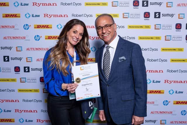 Lisette van Riel is celebrating after receiving a certificate from Dragon's Den entrepreneur Theo Paphitis. Photo: Doggy Warriors