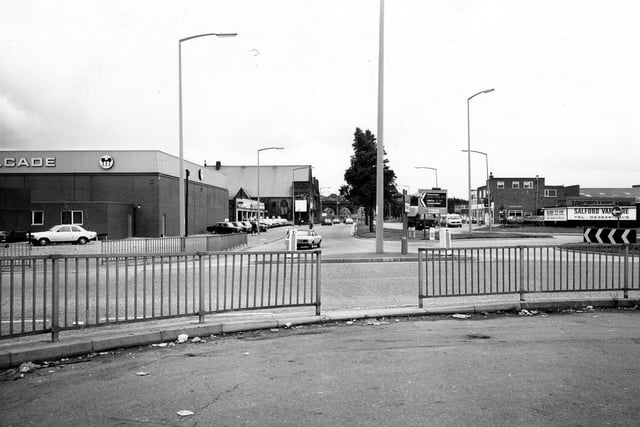 A roundabout on Domestic Street, looking south-east towards the railway viaduct, the arches of which can be seen in the distance. On the left is the junction with Holbeck Lane, with Melcade Ltd, Wine and Spirit Merchants on the corner. On the right is Salford Van Hire Ltd.