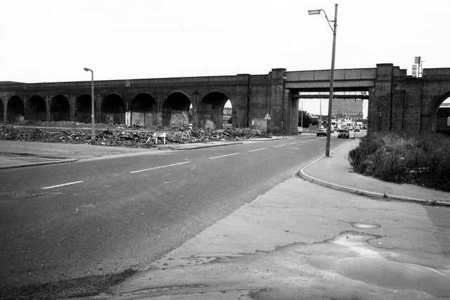 The old junction with Ingram Road is on the left, adjacent to an area of wasteground. This area was shortly to be developed as Ingram Gardens and Ingram Close. A gasometer can be seen in the distance through the archway.