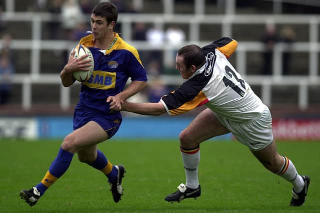 Rhinos' Richard Mathers gets away from Rob Parker in the 2002 academy Grand Final. Picture by Mel Hulme.