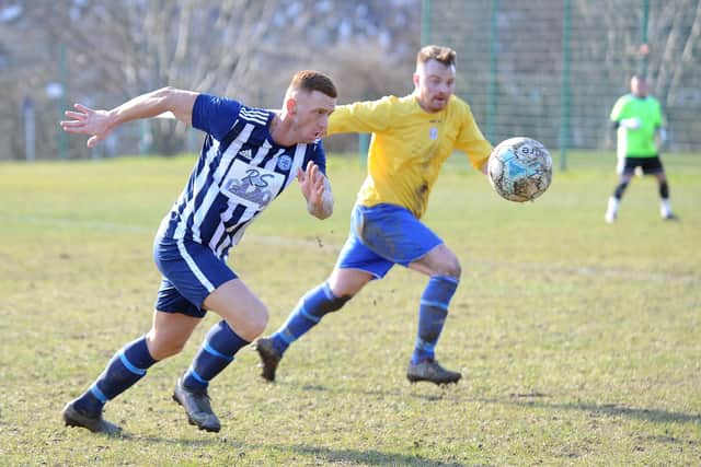 Ryan  Sharrocks, of Wortley, keeps a close eye on the ball, chased by Farsley's Neil Stevens. Picture: Steve Riding.