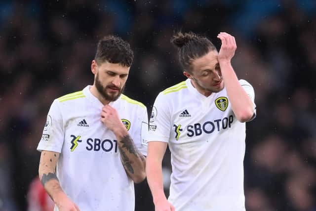 Mateusz Klich and Luke Ayling react to Leeds United's 6-0 defeat to Liverpool. Pic: Laurence Griffiths.