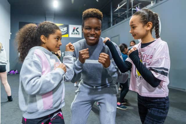 Nicola Adams, helping youngsters (left to right) Mya France, aged 8, and Mylee Greener, aged 9. Photo: James Hardisty