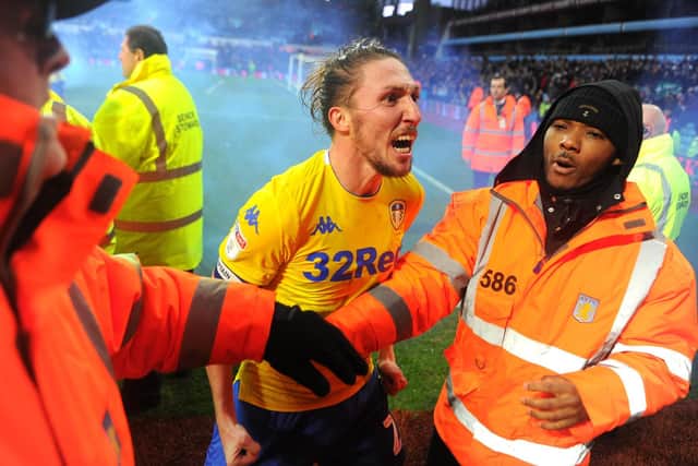 Luke Ayling celebrates with the travelling Leeds United fans after Kemar Roofe scored an injury-time winner for the Whites at Villa Park in December 2018. Pic: Nathan Stirk.