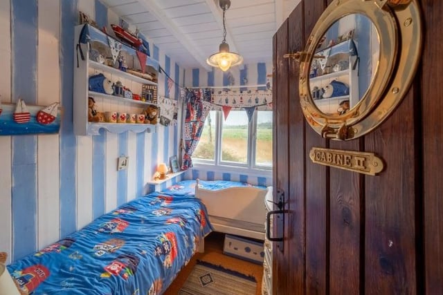 The third bedroom is a special kid’s bedroom which has a nautical theme and two single beds built into the hull with lovely views over the reserve.