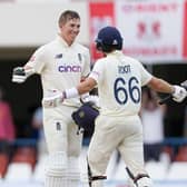 England's Zak Crawley celebrates with captain Joe Root after scoring a century against West Indies. (AP Photo/Ricardo Mazalan)