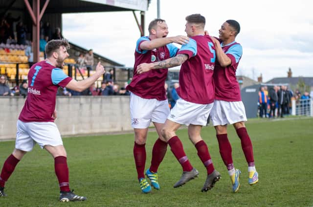 Sam Pashley celebrates his winning goal with Emley AFC teammates. Picture: Mark Parsons