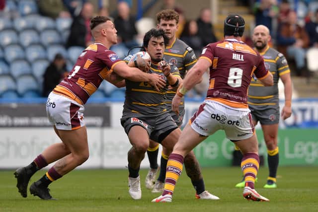 Castleford's Mahe Fonua is stopped by Owen Trout and Chris Hill.  Picture: Bruce Rollinson.