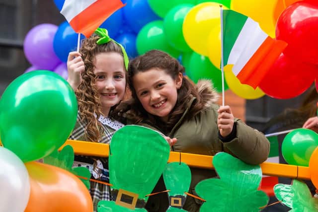 The Leeds St Patrick's Day Parade. PIctured Phoebe Smith, and Charlotte Allan, both aged 8, on the shared float of Christ The King Primary School, Bramley, and St Paul's Catholic Primary School, Alwoodley, Leeds. Photo: James Hardisty