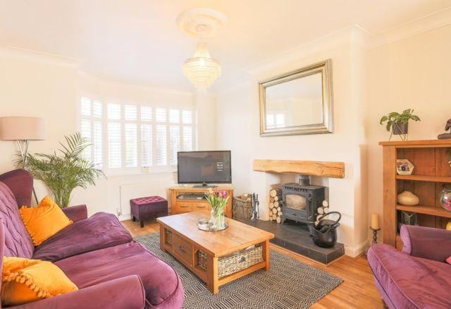 The living room is a great space with a half bay window looking across to the front and a fireplace with wood burning stove.