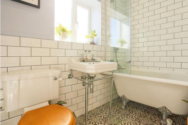 The family bathroom has a modern suite which includes a roll top bath. It is a well-designed and modern room.