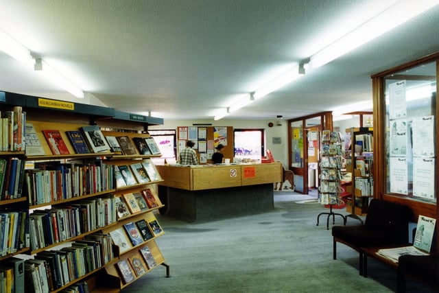 Inside Chapeltown Branch Library on Reginald Terrace. Shelves of African/Caribbean books are on the left. The counter is in the middle and entrance to the right.