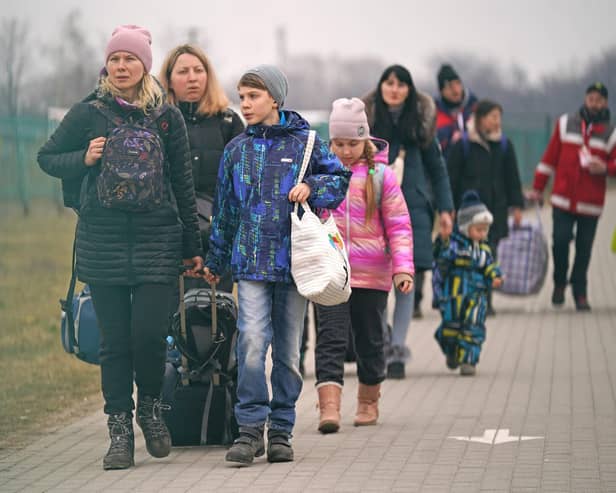 People crossing the border point from Ukraine into Medyka, Poland. Photo: PA Wire/PA Images