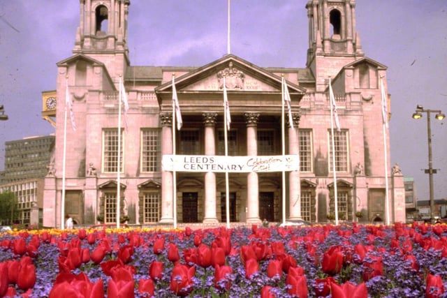 Civic Hall from Nelson Mandela Gardens. A large sign dominates the front of the Civic Hall and promotes 'Leeds Centenary'. One hundred years before on the 13th February 1893 Leeds became a City by Royal Charter of Queen Victoria.