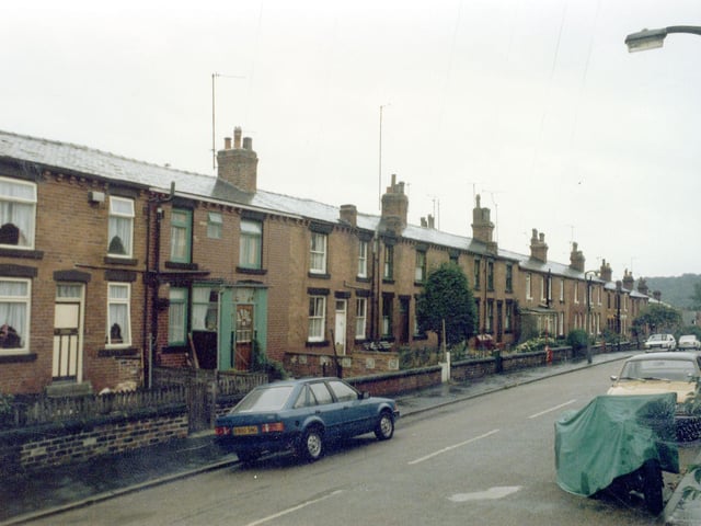 Back-to-back red brick terraced housing on Highbury Road looking down towards Monkbridge Road from the direction of Highbury Mount.