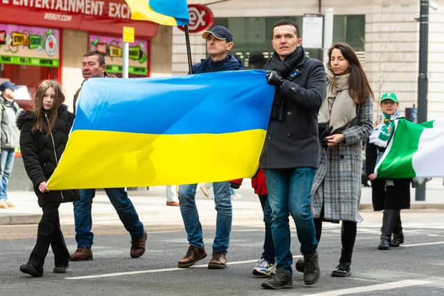People taking part in the St Patrick's Day parade in Leeds on Sunday carry a Ukrainian flag as a gesture of solidarity. Picture: James Hardisty