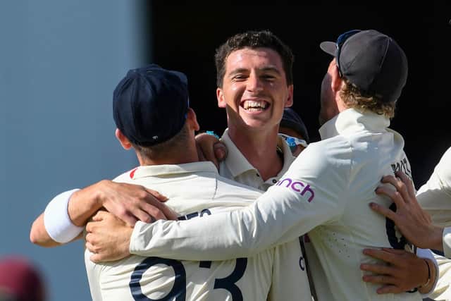 England's Matt Fisher celebrates his first test wicket, the dismissal of John Campbell of West Indies. (Photo by RANDY BROOKS/AFP via Getty Images)