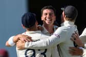 England's Matt Fisher celebrates his first test wicket, the dismissal of John Campbell of West Indies. (Photo by RANDY BROOKS/AFP via Getty Images)