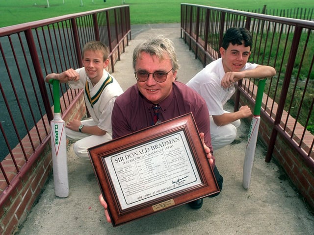 Australian exchange teacher, Dave Swann, holds his certificate signed by cricket legend Don Bradman at Farnley Park High School in September 1998. He is pictured with pupils, Warren Brewer, left, and Andrew Punter.