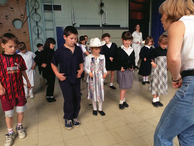 Pupils from Ryecroft Primary School watch carefully as Judy Pearson, from Armley Sports and Leisure Centre, instructs them in a line-dancing session in July 1996.