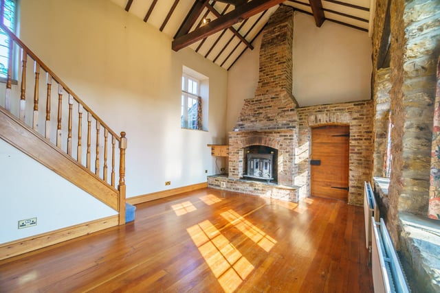 You enter this spacious home and lead straight into the grand dining-hall with a striking fireplace and an original vaulted ceiling.