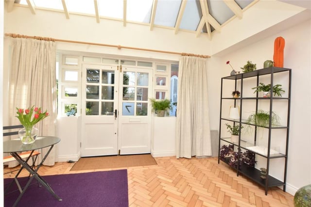 An impressive reception entrance has a high vaulted conservatory-style ceiling.