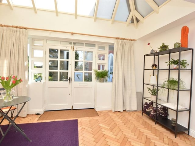 An impressive reception entrance has a high vaulted conservatory-style ceiling.