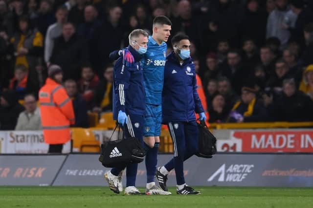 Leeds United goalkeeper Illan Meslier limps off with the assistance of medical staff. Pic: Laurence Griffiths.