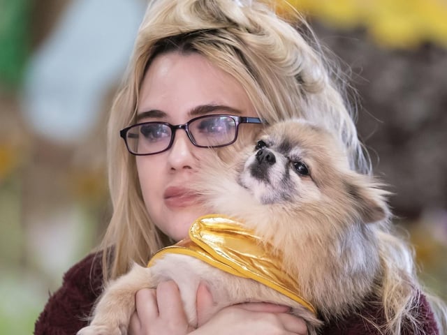 Tasha Quinn hugs her dog Dexter the Pomeranian