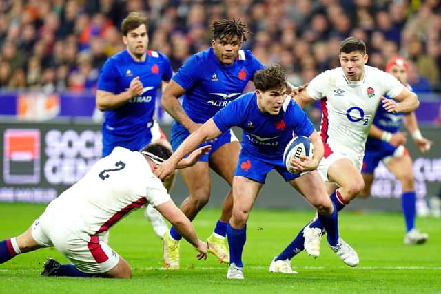 France's Antoine Dupont gets away from England's Jamie George to score his side's third try at the Stade de France Picture: Adam Davy/PA