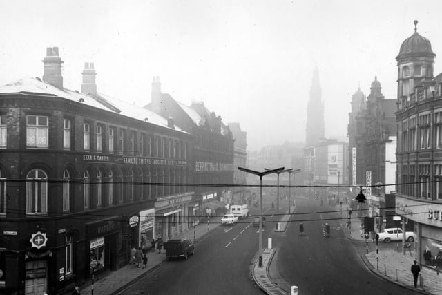 Duncan Street looking west towards Boar Lane, taken from the junction with Call Lane in January 1964. On the left are two public houses, the Star & Garter and the Duncan. Shops in between include Watson tailors and W.W. Slee, antique dealer. Further along is Berrington & Co., boot manufacturer. On the right are Burton's tailors, Rawcliffe's tailors, Saxone Shoes and the spire of Holy Trinity Church.