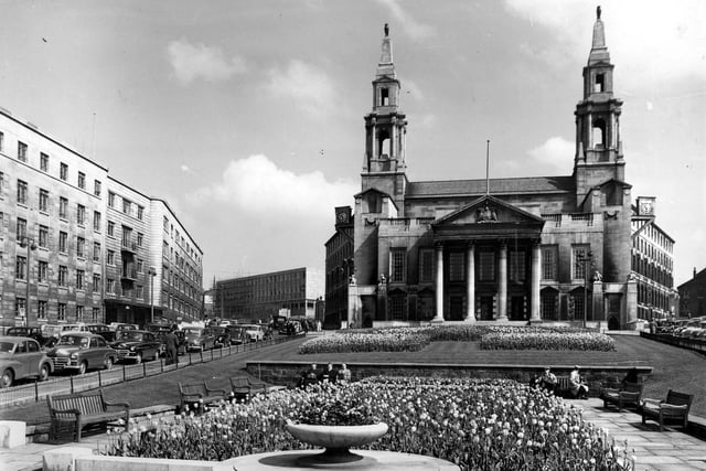 Leeds Civic Hall with the Leeds Polytechnic under construction to the left. Cars are parked in Calverley Street, left, and Leeds General Infirmary is at the left edge. The Civic Gardens in the foreground were later dedicated to Nelson Mandela in support of his struggle against apartheid.