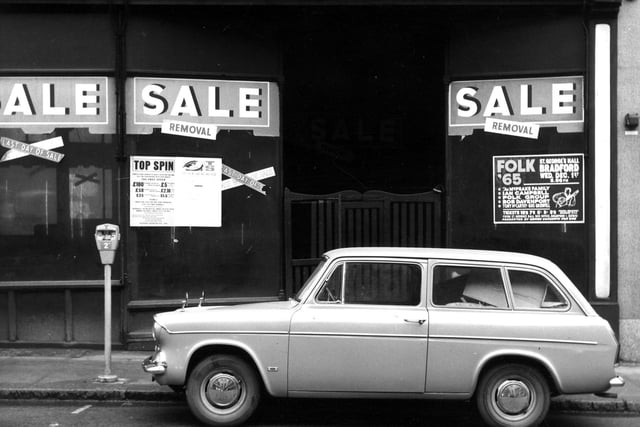 Kirkgate showing the former premises of Scarr's Ltd., hardware merchants and ironmongers in February 1966. A car is parked beside a parking meter outside.