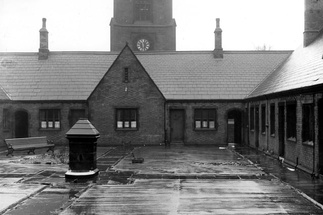 Harrison's Almshouses on Wade Lane with St John's Church in the background pictured in February 1962. They were the gift of Leeds merchant John Harrison, who left £1,000 as an endowment and built in 1653 for 40 poor women. This photograph was taken shortly before demolition.