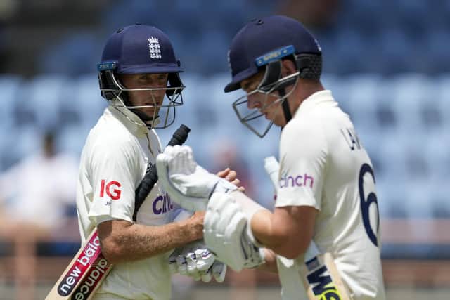 England's captain Joe Root leaves the field, dismissed for no runs, as teammate Dan Lawrence enters to bat during day one of their third Test cricket match against West Indies at the National Cricket Stadium in St. George, Grenada. (AP Photo/Ricardo Mazalan)