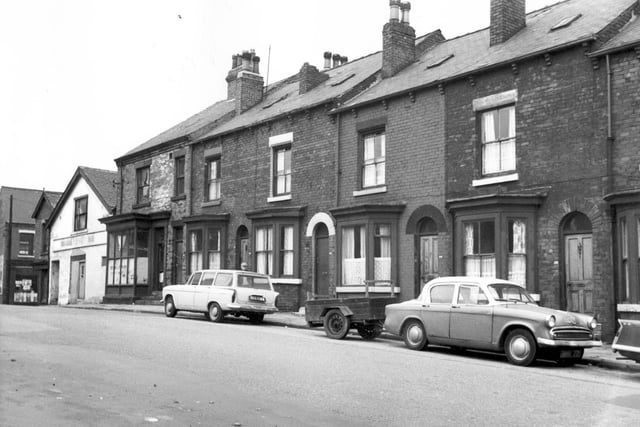 Oatland Lane in August 1967.  On the left is Servia Grove with a branch of Leeds Co-operative stores. The white building was formerly a gymnasium. This was the end of Servia Road. Oatland Lane was previously known as Camp Road, this was the upper part of it; the lower part remained Camp Road for some time but is now Lovell Park Road.