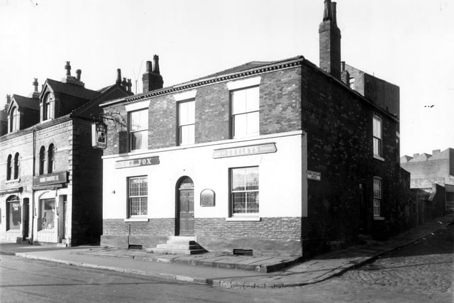 Woodhouse Street in October 1962. On the left is the premises of R. Mallory, tailor, then a ladies clothes shop, a sign over the window reads 'Farana Transport Ltd'. The Fox Public House sold Tetleys beer, the landlady was Minnie Green. Cross Chancellor Street is on the right. Perseverance Mills, business of Peter Laycock is behind the buildings on Woodhouse Street with an entrance in view.