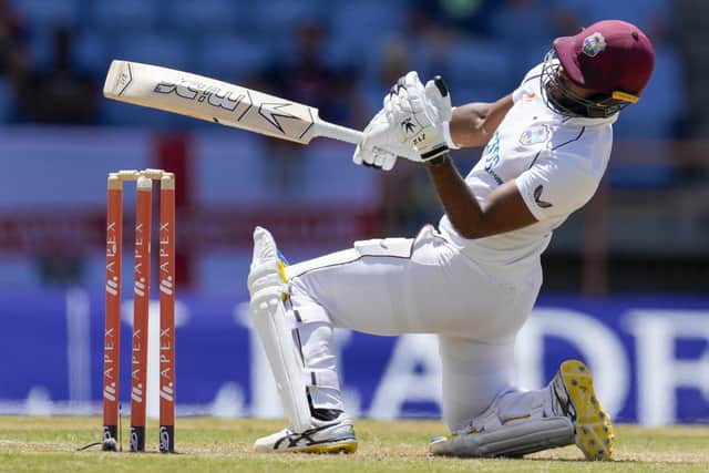 West Indies' John Campbell kneels after being hit by a delivery by England's Craig Overton during day two of their third Test cricket match at the National Cricket Stadium in St. George, Grenada, Friday, March 25, 2022. (AP Photo/Ricardo Mazalan)