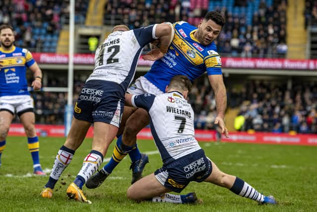 Leeds Rhinos' Rhyse Martin is tackled by Warrington's Oliver Holmes and George Williams.  Picture: Tony Johnson.