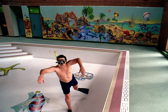 Lifeguard Steven Cockshott in the empty pool at Kirkstall Leisure Centre after work had been completed on decorating it with attractive murals.