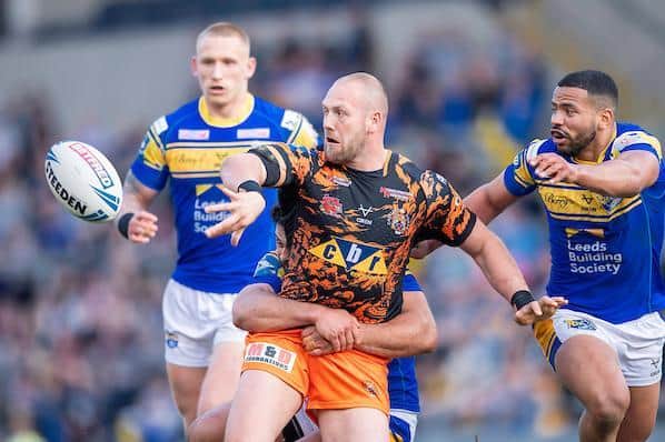 Tigers' Liam Watts offloads as Kruise Leeming closes in. Picture by Allan McKenzie/SWpix.com.