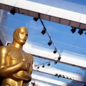 An Oscar statue is seen along the red carpet outside the Dolby Theater in Los Angeles, California, on March 26, 2022, one day before the 94th Academy Awards.