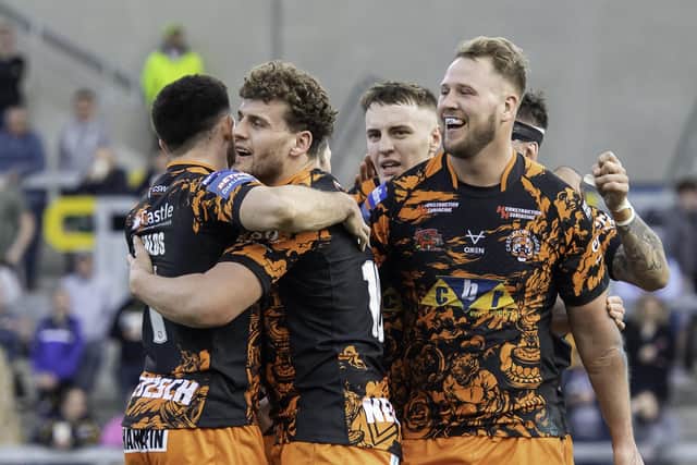 Castleford Tigers' George Lawler is congratulated on his try against Leeds Rhinos. Picture: Allan McKenzie/SWpix.com.