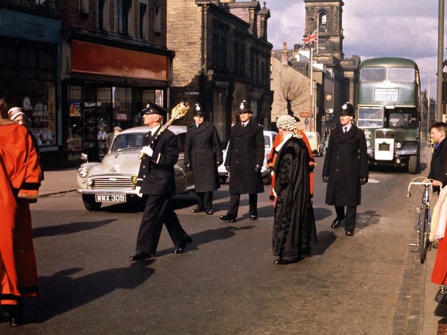 The civic procession travels down Queen Street from the Town Hall to the Wesleyan Church. The mace-bearer can be seen clearly: the Mayor, Mrs. Anne Clayton, in red, is hidden behind the Town Clerk, E. V. Finnigan.