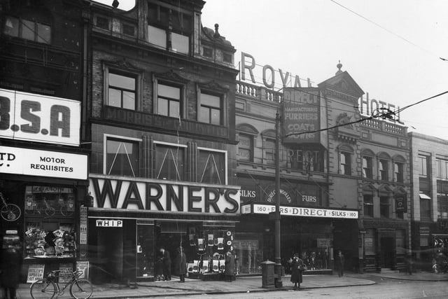 Shops on Briggate in March 1936. Pictured, from left is Watson Cairns, Direct Woollen Co, Royal Hotel, Lamberts Chambers. Entrance to Bowers Yard and Whip public house can also be seen.