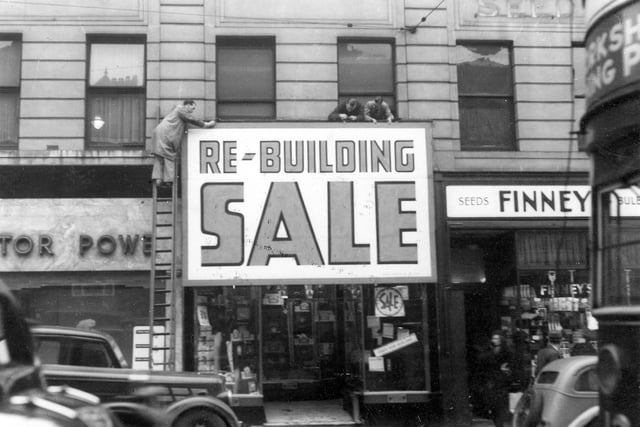 Stone's Radio shop on Briggate in January 1939 with signs being put up which state 'Re-building sale'.