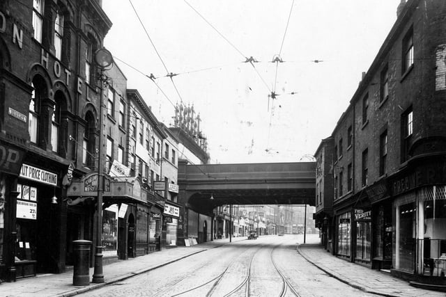 Looking from the junction of Briggate with Call Lane (right) and Swinegate (left) through the London and North Eastern Railway bridge on Lower Briggate in June 1933. The Golden Lion Hotel can be seen on the left with Fred Verity and Son, Ironmongers on the right.