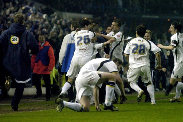David Healy is mobbed by team mates after scoring the last gasp winner.